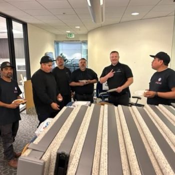 Office furniture liquidation sale with team members discussing options and arrangements.