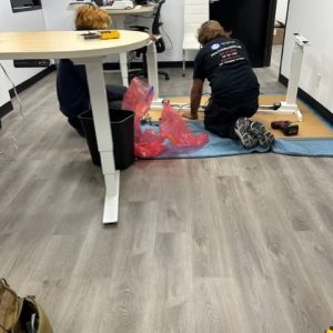 Office furniture installation and setup process in progress.