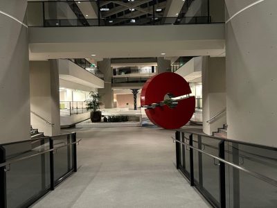 Contemporary office interior with modern art sculpture and open walkways.